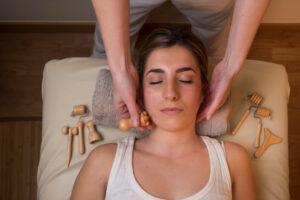 Young woman on massage table receiving lymphatic drainage massage