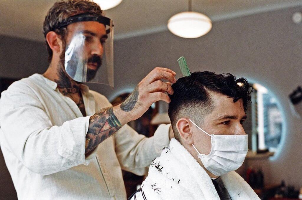 barber Dan Glass, of Dans Barbershop, cutting a clients hair