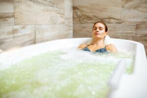Young woman receiving hydrotherapy in a spa
