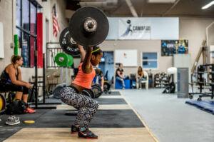 Woman doing snatches At boutique gym