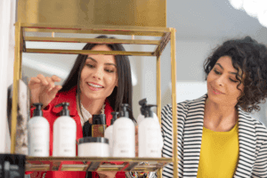 Two women look at beauty and wellness products in a store