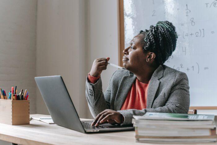 Black woman thinking while looking out a window