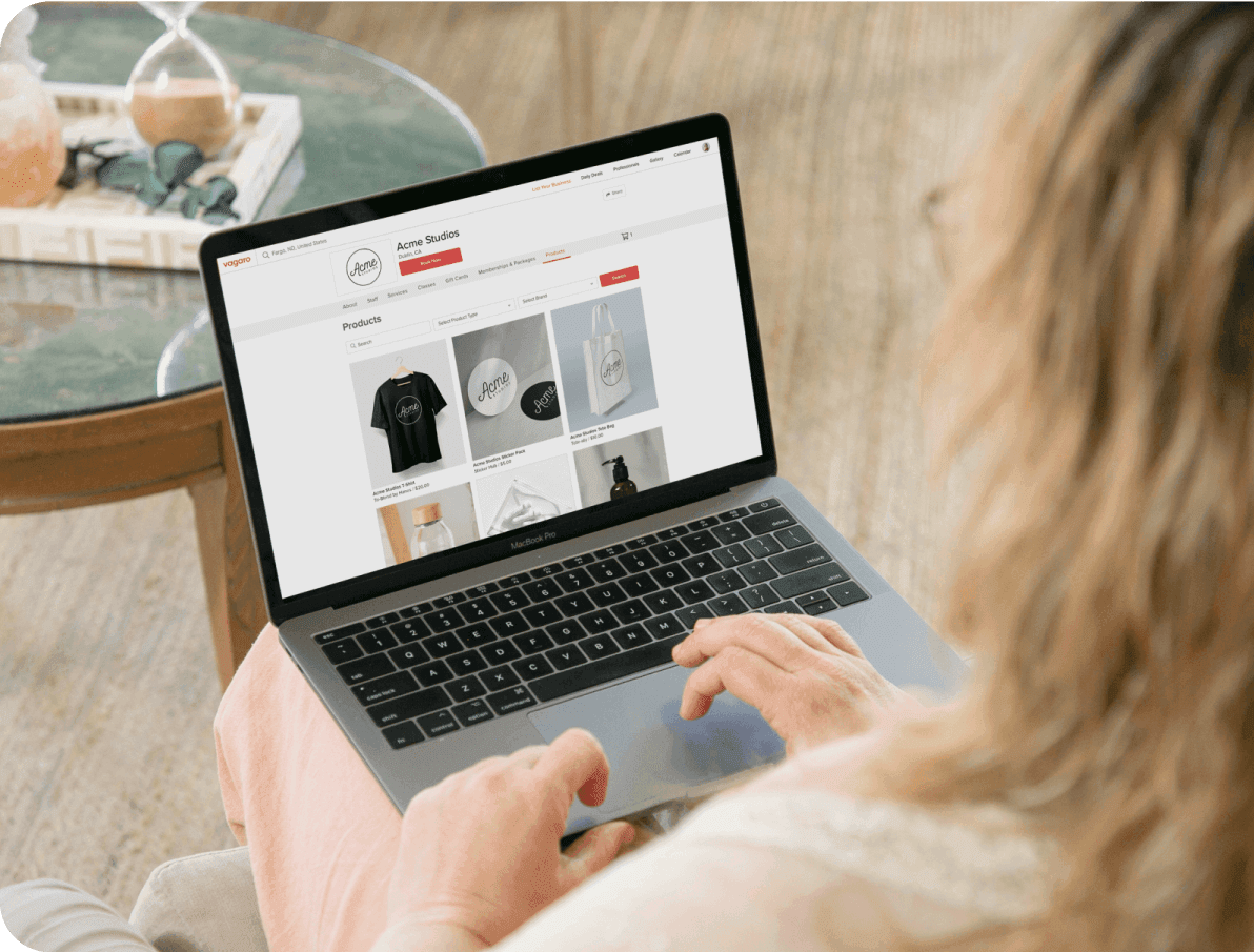 A person on laptop viewing the online store of a salon business using Vagaro.