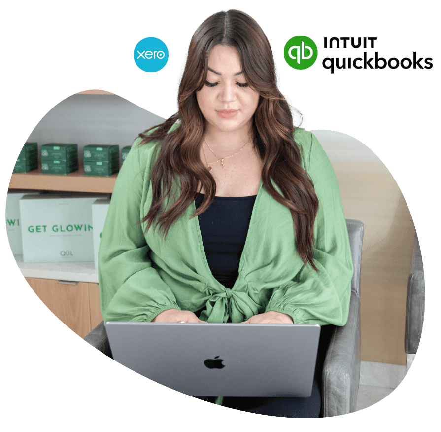 An image of a customer on a laptop viewing Vagaro's reporting in our salon, spa and fitness software.