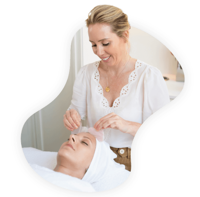 An image of skincare specialist Lisa Franklin doing a facial on a customer.